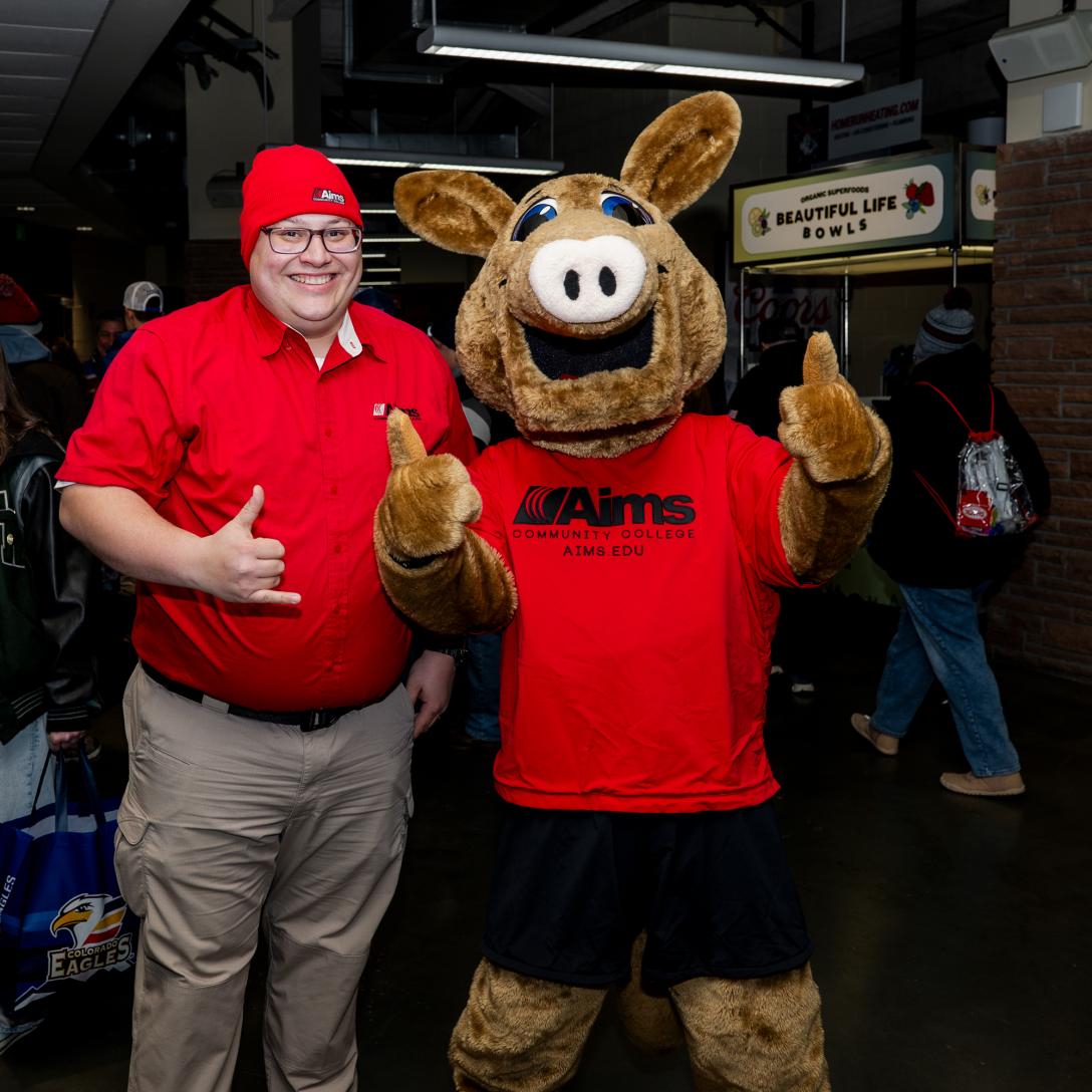 Andrew Brown with Arty the Aardvark at Aims Night at a Colorado Eagles Game