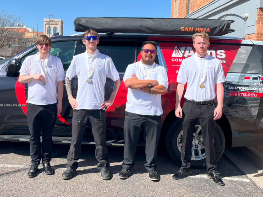Aims UAS Team standing in front of a truck