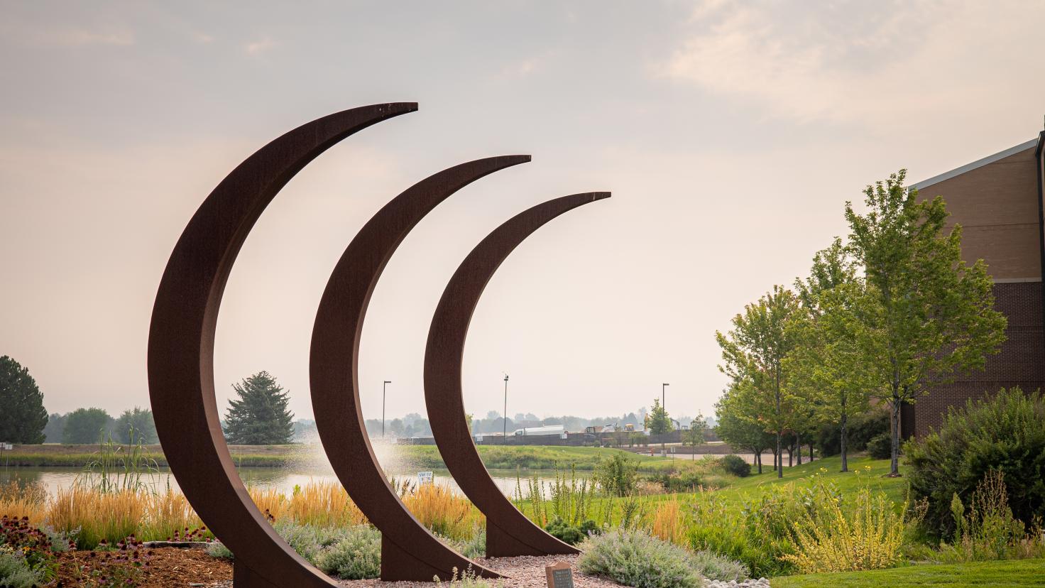 A scenic photo of a metal sculpture on the Aims Community College Greeley Campus