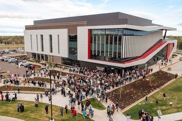 Guests and graduates gathered outside the Aims Welcome Center