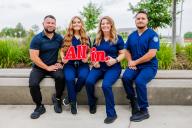 Lozano Family photo holding "All in" sign