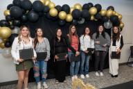 students standing with awards against balloon backdrop