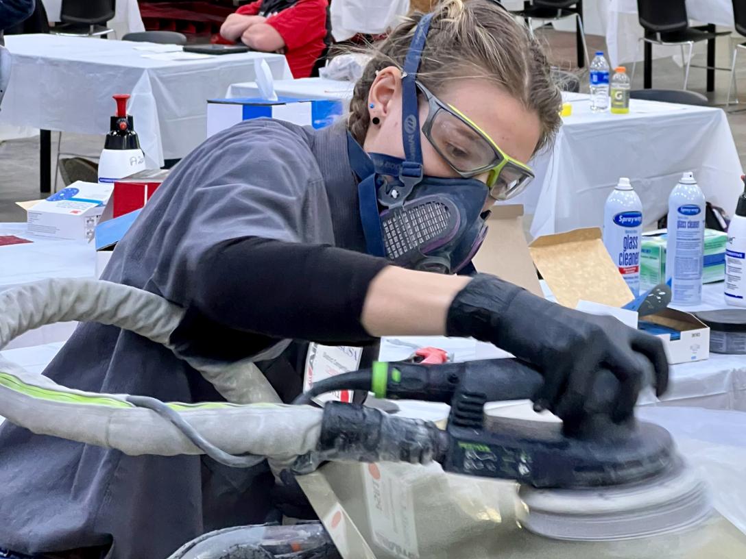 Kayleigh Kerr buffing a car at Skills USA contest