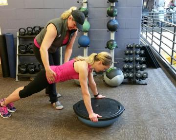 A personal trainer working with a client at Chilson Recreation Center in Loveland