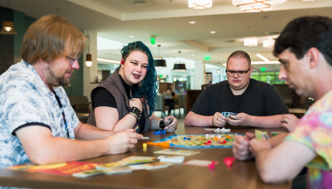 Aims Community College students playing a board game